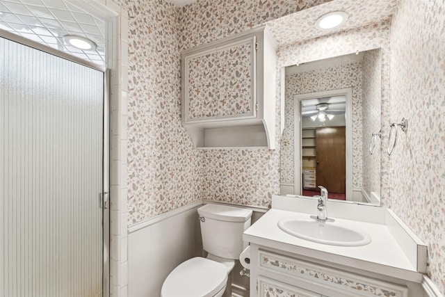 bathroom with vanity, toilet, and an enclosed shower