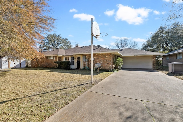 single story home featuring cooling unit, a garage, and a front lawn