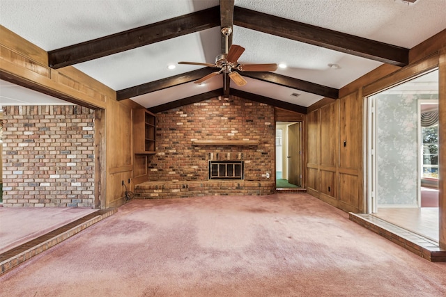 unfurnished living room featuring lofted ceiling with beams, carpet flooring, a fireplace, and a textured ceiling