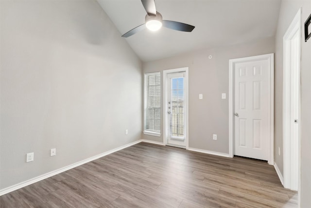 spare room featuring ceiling fan, vaulted ceiling, and light wood-type flooring