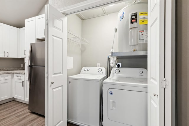 laundry area featuring independent washer and dryer and light hardwood / wood-style flooring