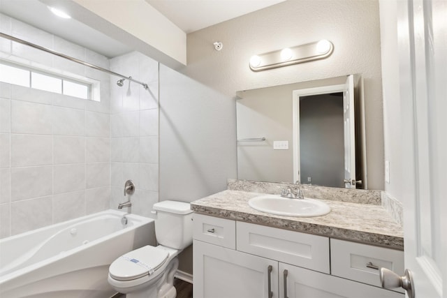 full bathroom with vanity, toilet, and tiled shower / bath combo