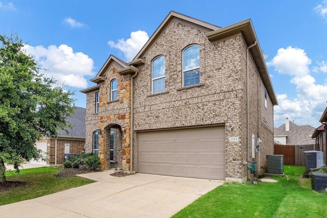 2365 Elm Valley Dr, Little Elm, TX 75068 - view of front facade with driveway, an attached garage, cooling unit, and stone siding