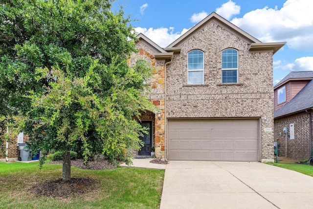 2365 Elm Valley Dr, Little Elm, TX 75068 - view of front of property featuring concrete driveway, an attached garage, stone siding, and a front lawn