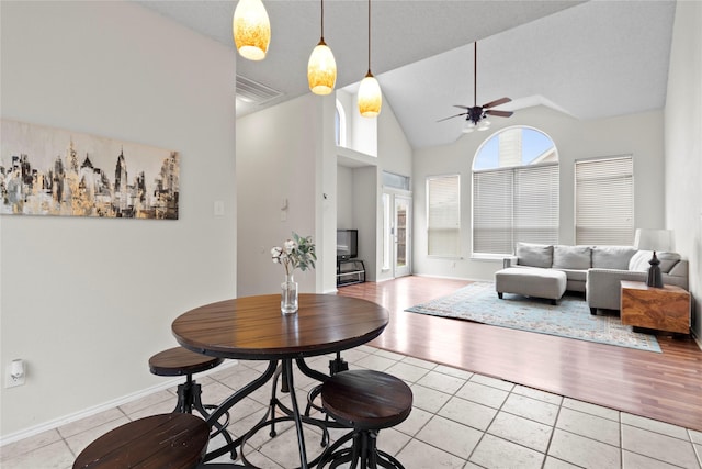 interior space featuring high vaulted ceiling and ceiling fan