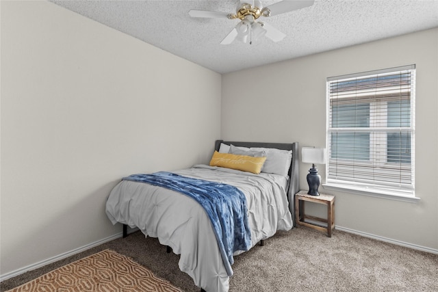 bedroom featuring ceiling fan, carpet, and a textured ceiling