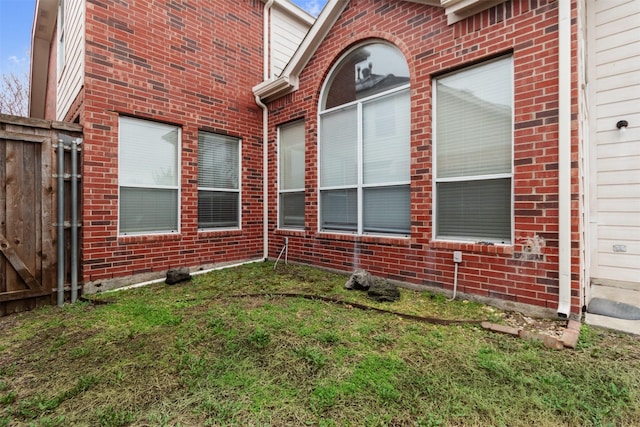 view of side of home featuring a lawn