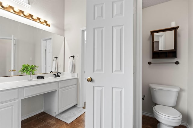 bathroom featuring vanity, tile patterned floors, and toilet