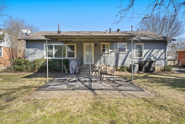 rear view of house with cooling unit, a yard, and a patio area