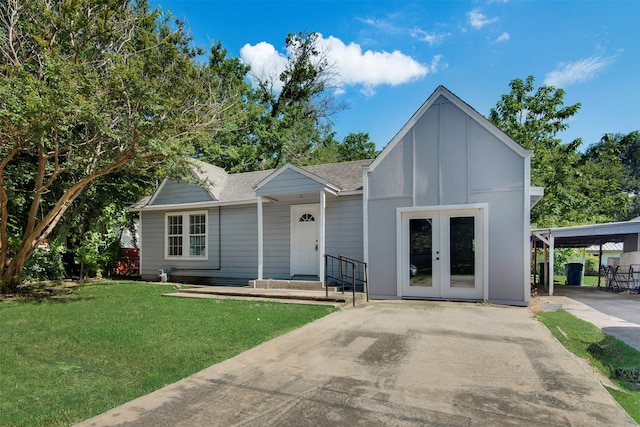 view of front facade with a carport, a front yard, and french doors