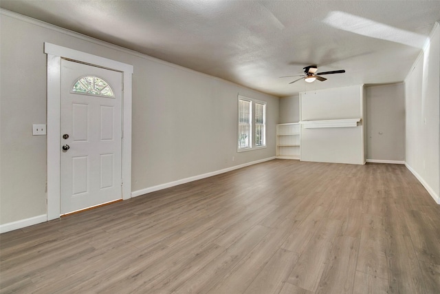 entrance foyer with ceiling fan, light hardwood / wood-style floors, and a textured ceiling