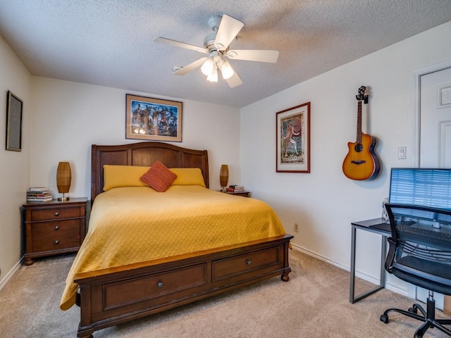 bedroom with ceiling fan, light colored carpet, and a textured ceiling