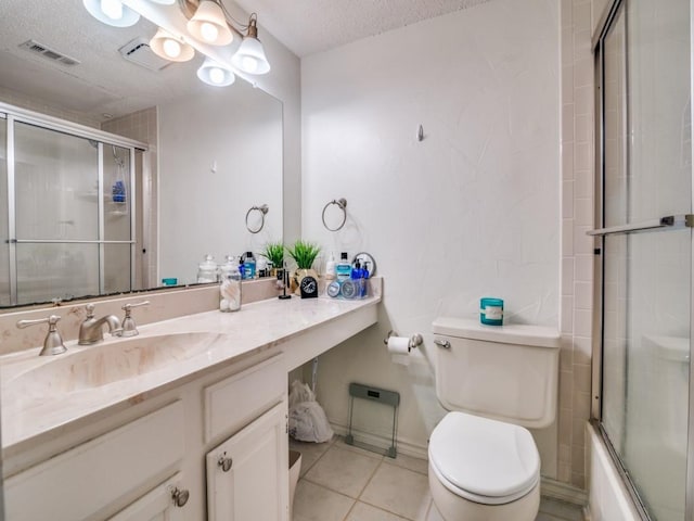 full bathroom featuring bath / shower combo with glass door, vanity, toilet, tile patterned floors, and a textured ceiling