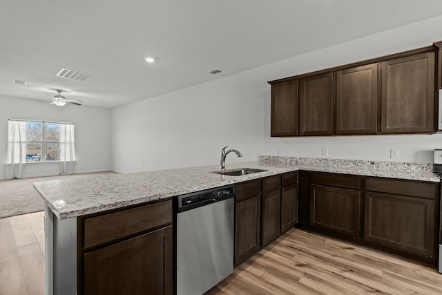 kitchen with sink, dark brown cabinetry, kitchen peninsula, stainless steel appliances, and light hardwood / wood-style flooring