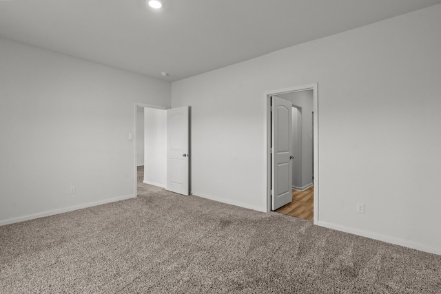 unfurnished bedroom featuring light carpet