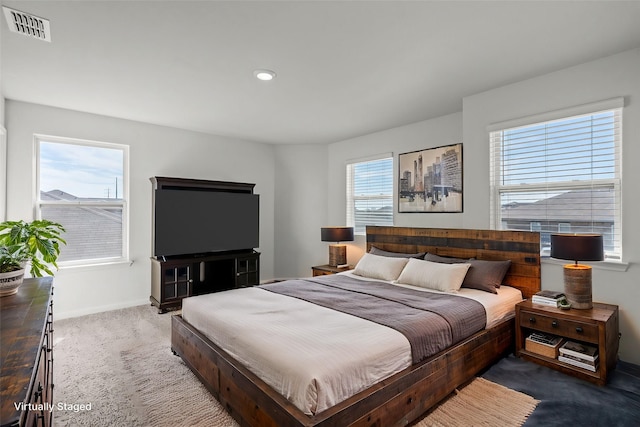 bedroom with multiple windows and carpet floors