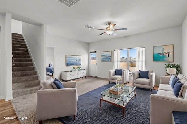 living room featuring wood-type flooring and ceiling fan