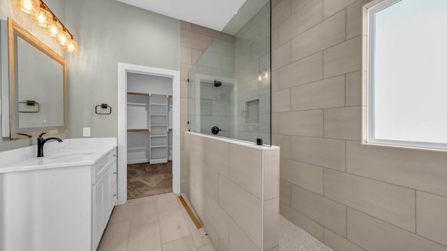 bathroom with vanity and tiled shower