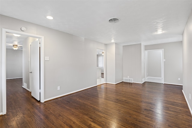 spare room with dark wood-type flooring and ceiling fan