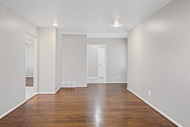 spare room with dark hardwood / wood-style flooring