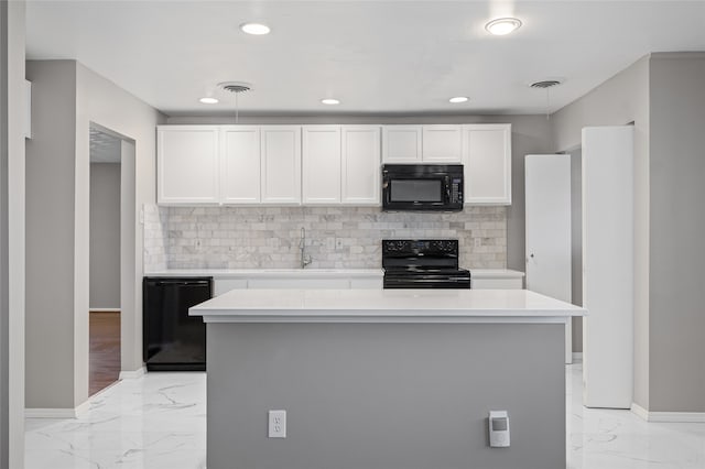 kitchen with backsplash, black appliances, a center island, and white cabinets