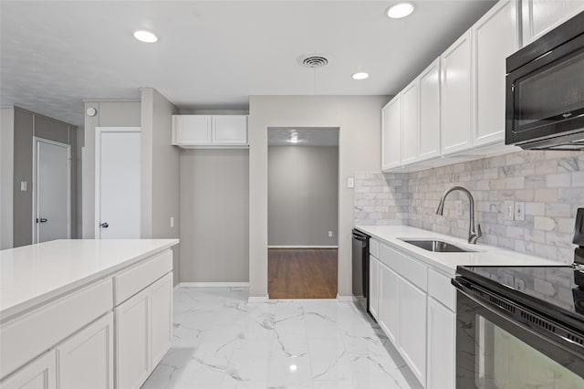 kitchen with white cabinetry, sink, decorative backsplash, and black appliances