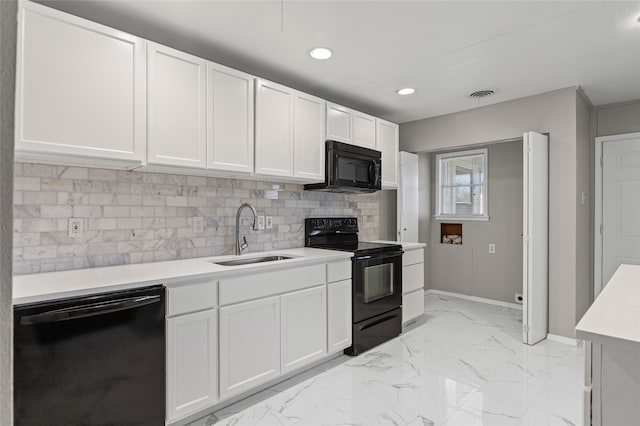 kitchen featuring decorative backsplash, sink, white cabinets, and black appliances