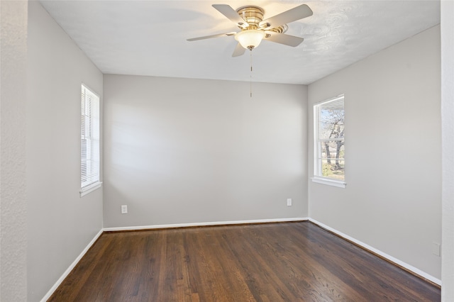 spare room with dark hardwood / wood-style floors and ceiling fan