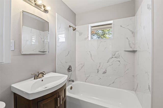 bathroom with vanity and tiled shower / bath