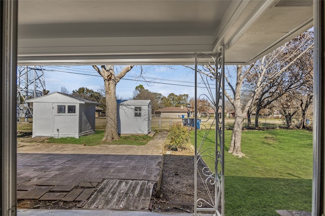 view of yard featuring a patio area and a storage unit