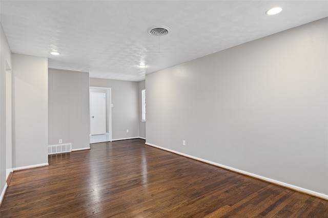 empty room with dark hardwood / wood-style floors