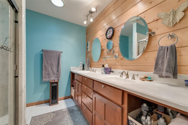 bathroom featuring vanity, a shower with door, tile patterned flooring, and wood walls