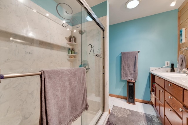 bathroom with vanity, an enclosed shower, and tile patterned flooring