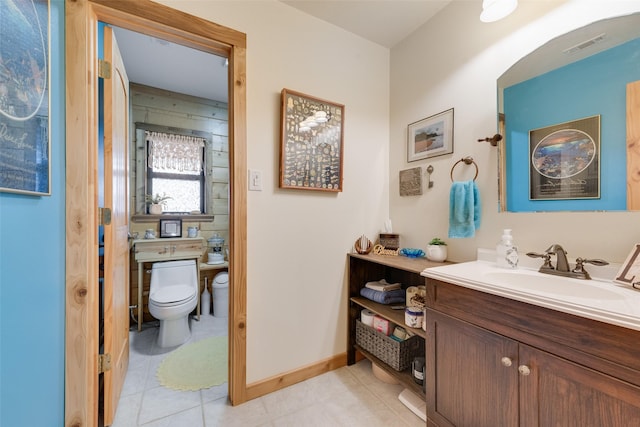 bathroom featuring vanity, toilet, and tile patterned flooring