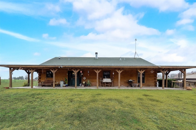 back of property featuring a yard and a patio area