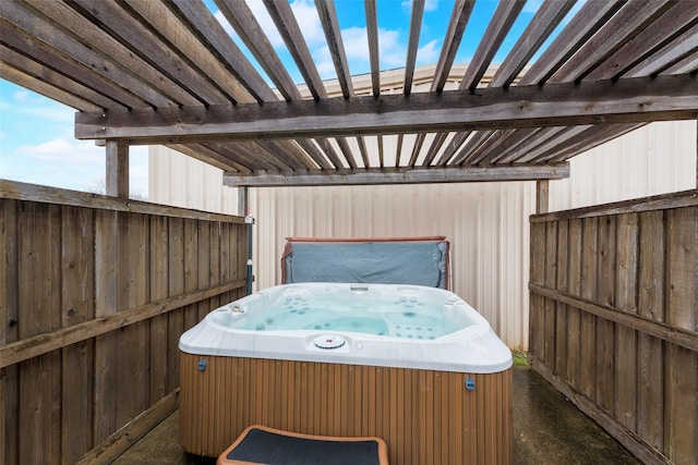 view of patio with a hot tub and a pergola