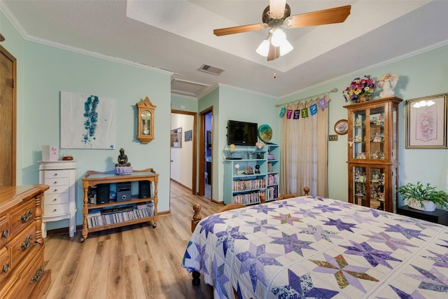 bedroom featuring ornamental molding, ceiling fan, and light wood-type flooring