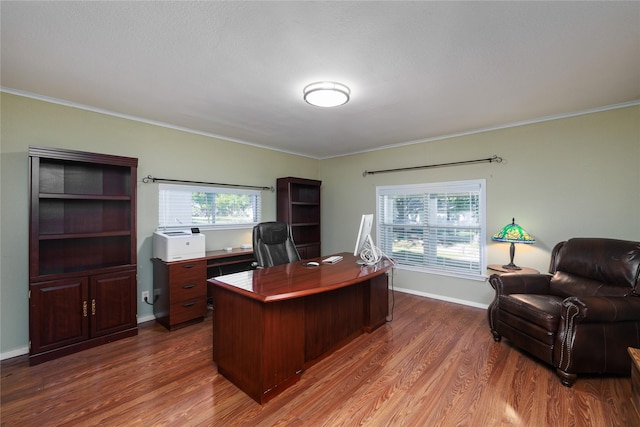 office area with dark hardwood / wood-style flooring and crown molding