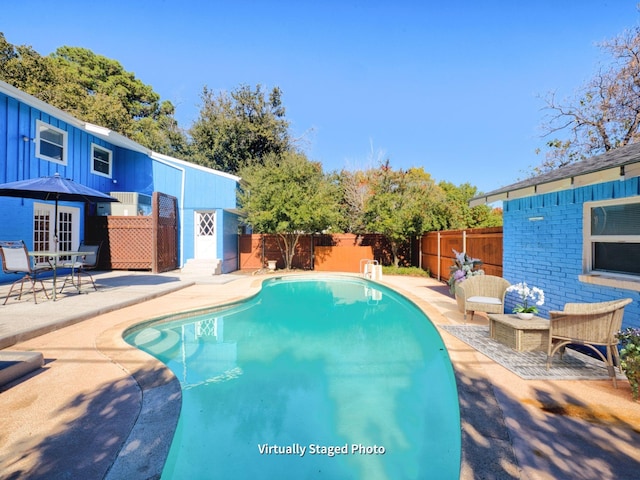 view of swimming pool with a patio