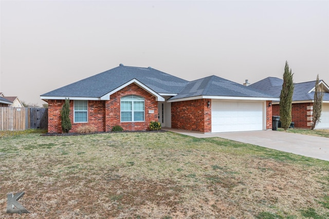 single story home with a garage, brick siding, fence, driveway, and a front yard