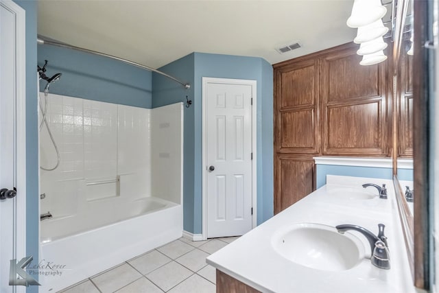 full bath featuring  shower combination, double vanity, a sink, and tile patterned floors