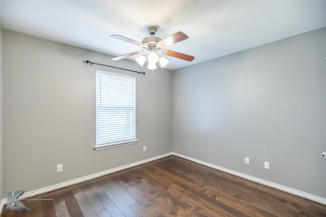 unfurnished room featuring a ceiling fan, dark wood finished floors, and baseboards