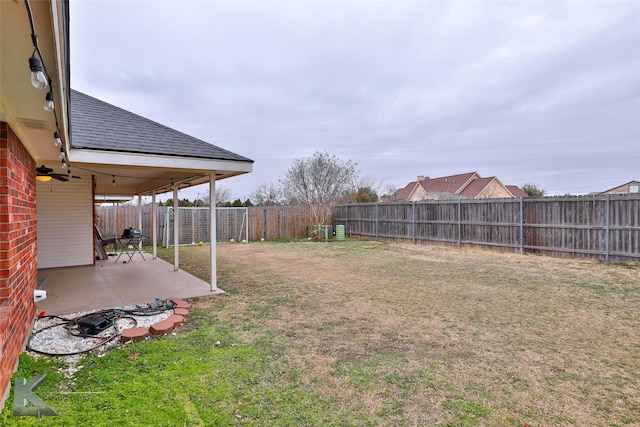 view of yard with a patio and ceiling fan