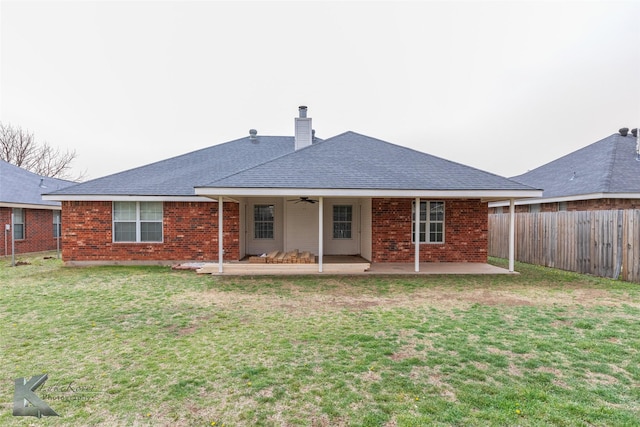 rear view of property featuring brick siding, a yard, a patio, ceiling fan, and fence