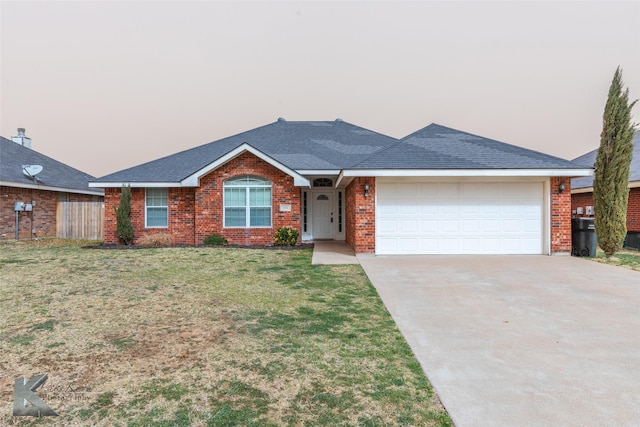 ranch-style house featuring a garage, concrete driveway, roof with shingles, a front lawn, and brick siding