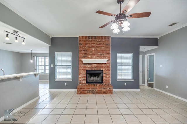 unfurnished living room featuring light tile patterned floors, ornamental molding, a fireplace, and visible vents