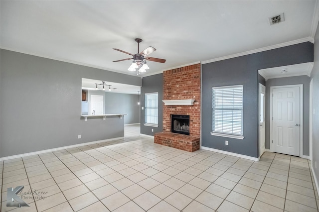 unfurnished living room featuring ceiling fan, visible vents, baseboards, a brick fireplace, and crown molding