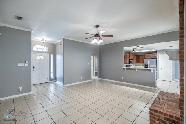 unfurnished living room with light tile patterned floors, baseboards, visible vents, and crown molding