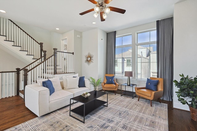 living room with ceiling fan and wood-type flooring