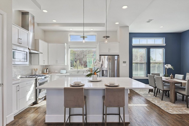 kitchen with white cabinetry, appliances with stainless steel finishes, and a center island